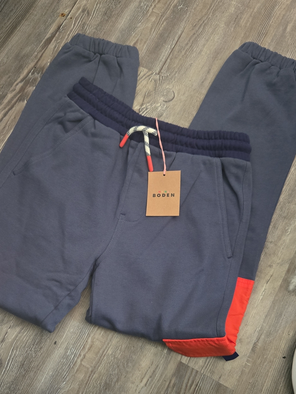 Mini Boden navy joggers with red accent and cream drawcord